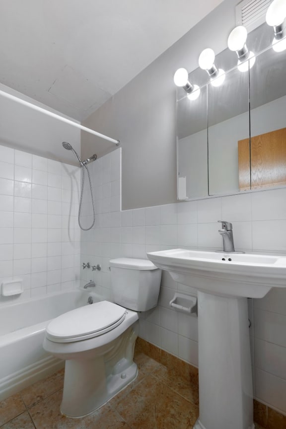 a bathroom with a toilet sink and a mirror
