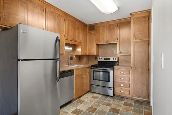 a kitchen with stainless steel appliances and wooden cabinets