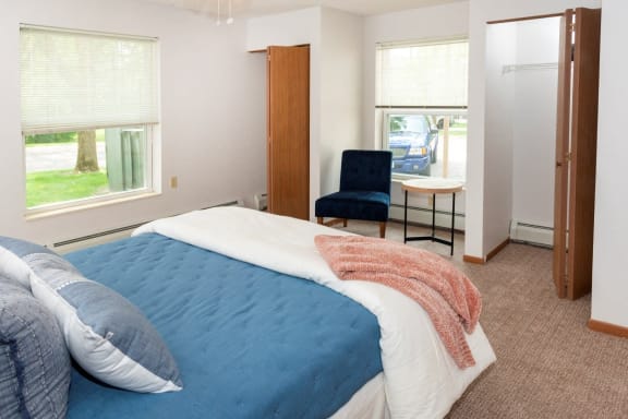 a bedroom with a bed and a desk with a chair