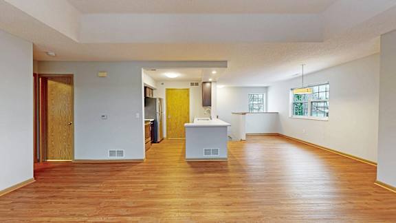 A room with wooden floors and white walls.
