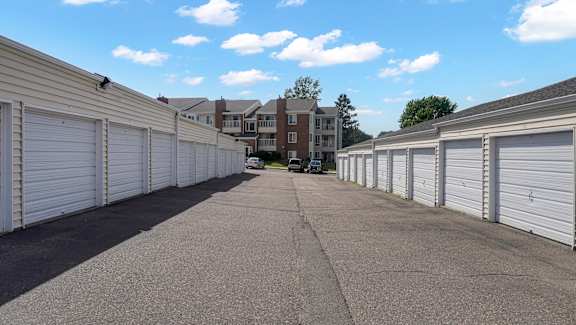 A long row of white garage doors are closed.