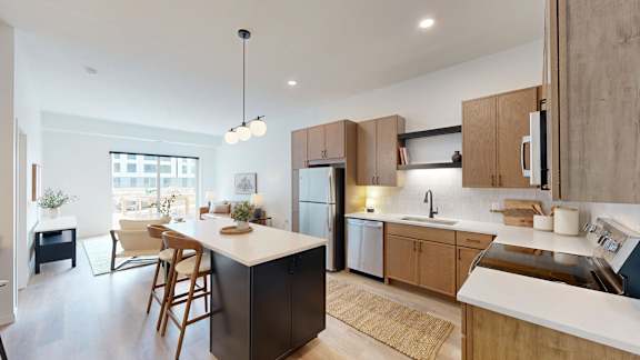 A modern kitchen with a large island and wooden cabinets.