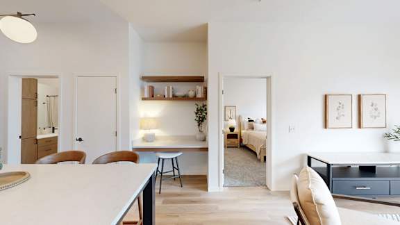 A modern kitchen with a dining table and chairs.