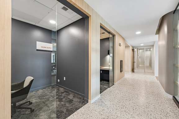 A hallway with a sign that says "Work Starts" on the wall.