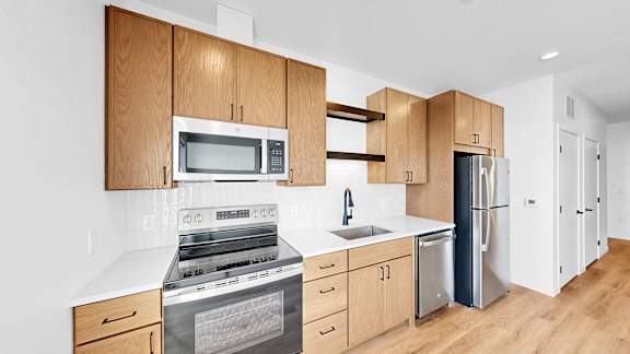A kitchen with wooden cabinets and stainless steel appliances.