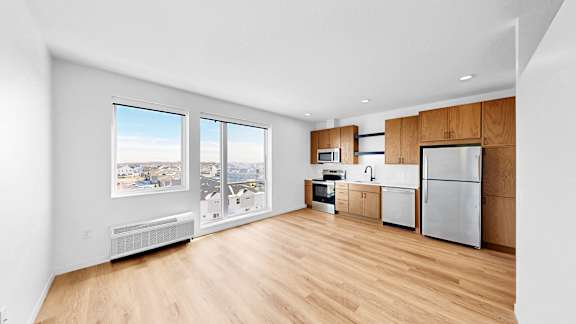 A kitchen with wooden floors and white walls.