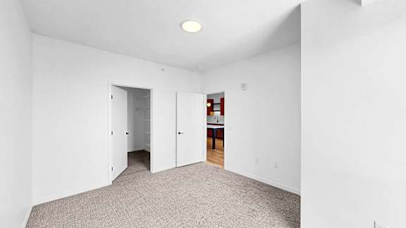 A room with white walls and a carpeted floor.