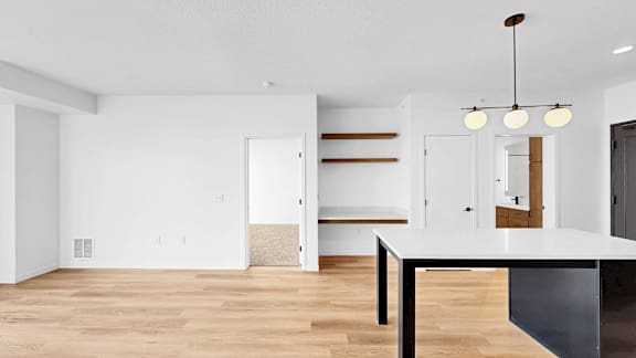 A modern kitchen with a white countertop and a black island.