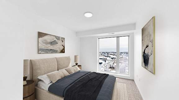 A bedroom with a large bed and two pieces of artwork on the wall.