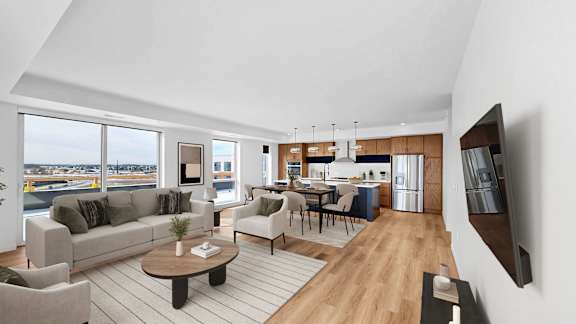 A modern living room with a large window overlooking the water.