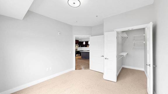 A white room with a doorway leading to another room.