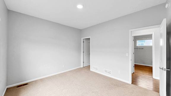 A room with white walls and a carpeted floor.