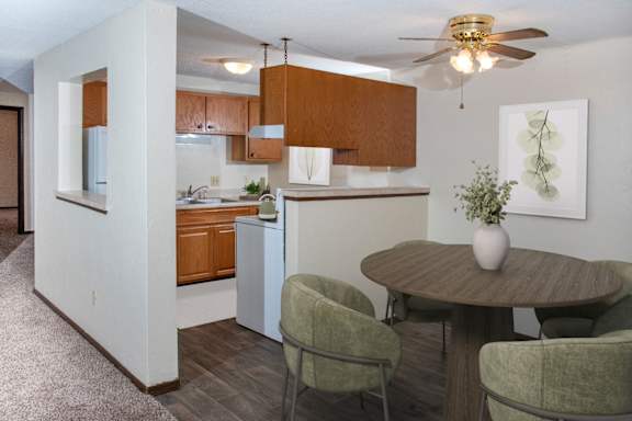 A kitchen with a table and chairs.