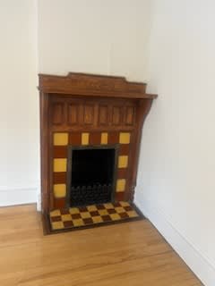 a fireplace in a room with a wooden floor