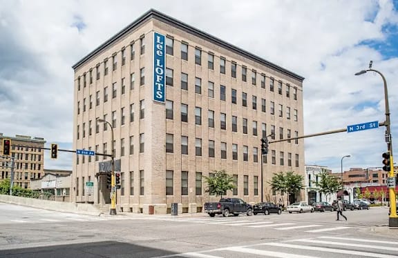 A large building with a blue sign on the side of it.