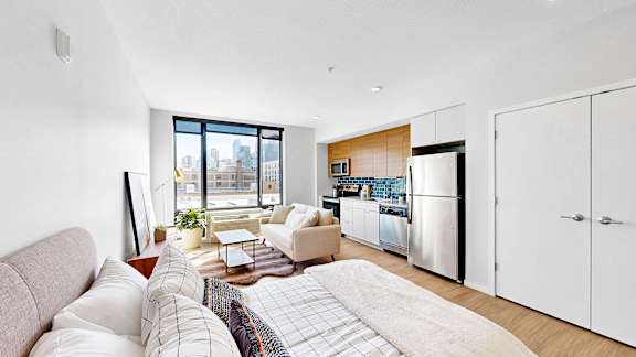 A modern living room with a large window overlooking the city.