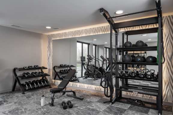 A well-equipped home gym with a variety of exercise equipment.