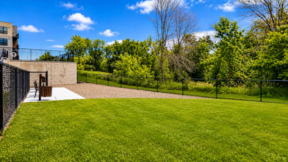 A large grassy area with a building in the background.