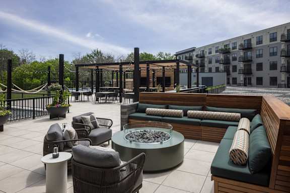 A patio with a fire pit and seating area.