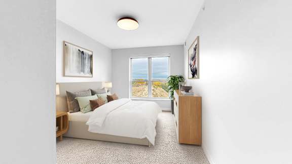 A bedroom with a large bed, a window with a view, and a wooden nightstand.
