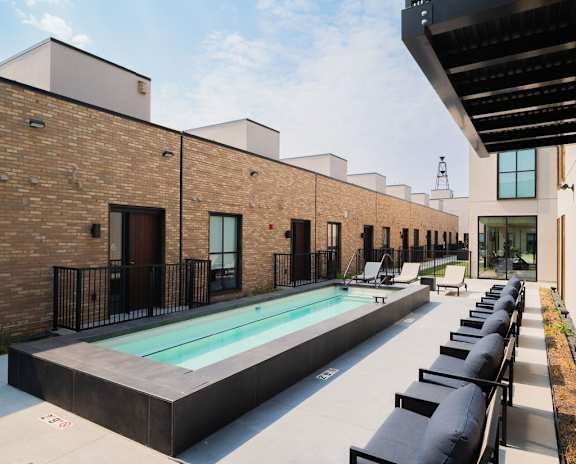 A modern building with a pool in the courtyard.