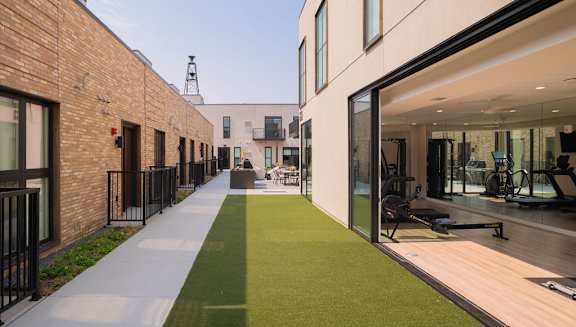 A modern building with a green lawn in front.