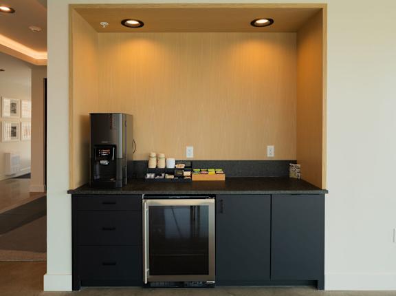 A kitchen with a black countertop and a black oven.