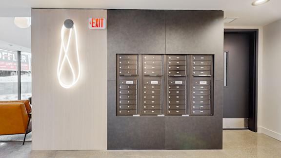A white neon exit sign is on the wall.