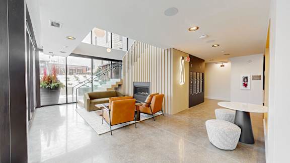 A modern living room with a fireplace and a glass door.