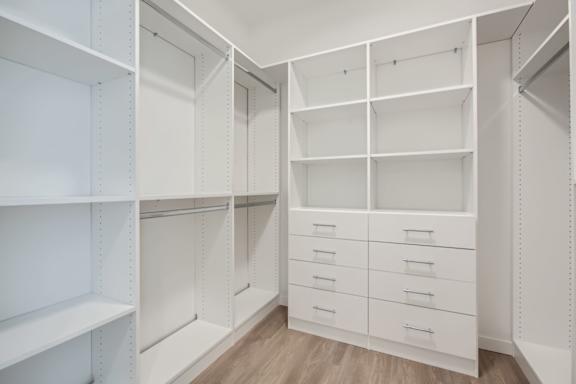 a large white closet with shelves and drawer at One West Drive Apartments, Minnesota, 55331