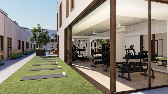 rendering of a fitness facility with weights and yoga mats in front of a building at One West Drive Apartments, Excelsior, Minnesota
