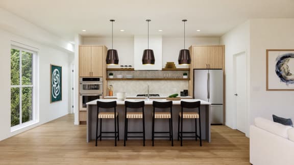 kitchen with a large island with black stools at One West Drive Apartments, Excelsior, Minnesota