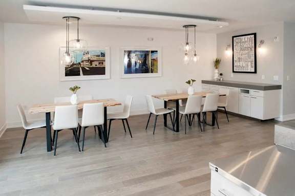 A modern dining room with a large table and chairs.