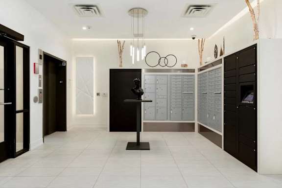 A hallway with a black door and a black pedestal in the middle.