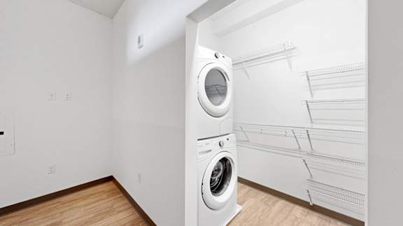 A white laundry room with a washer and dryer.