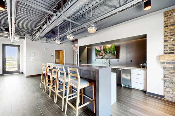 A kitchen with a dining table and chairs.