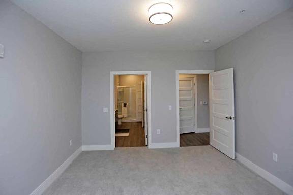A white room with a doorway leading to another room.