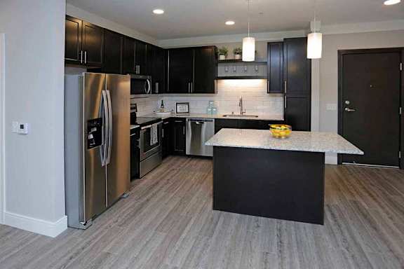 A modern kitchen with a black and white color scheme.