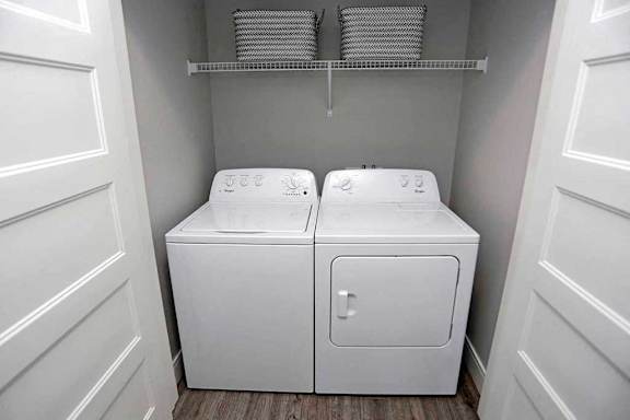 A white washer and dryer in a small laundry room.