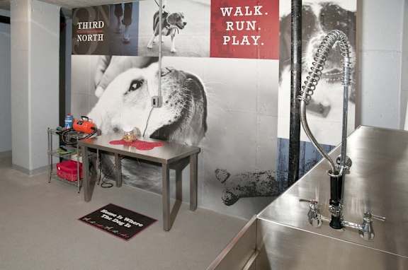 A sink in a room with a poster that says "walk run play".