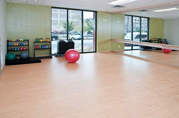 A gym with a red ball in the middle of the room.
