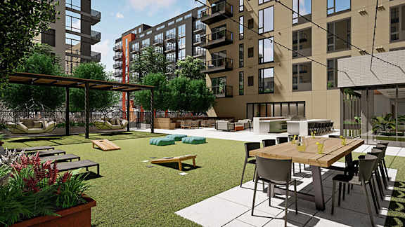 A modern outdoor seating area with a table and chairs.at Viridium Apartments, Minneapolis, MN