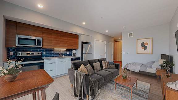 Living Area With Kitchen View at Viridium Apartments, Minneapolis, MN