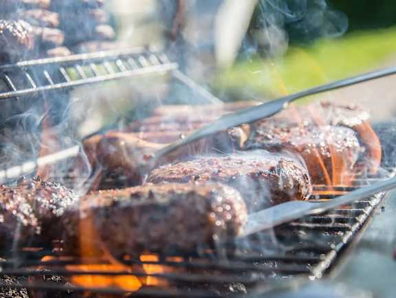 Hot dogs are being grilled on a barbecue at The Redwell Apartments, Minnesota