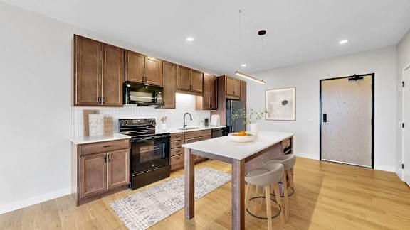 A kitchen with wooden cabinets and a white countertop.at The Rosalyn | Affordable 55+ Apartments in Bloomington, Bloominton Minnesota