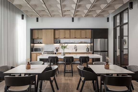 A modern kitchen with a dining table and chairs.