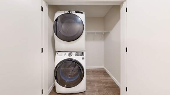 A white washing machine and dryer in a small laundry room.
