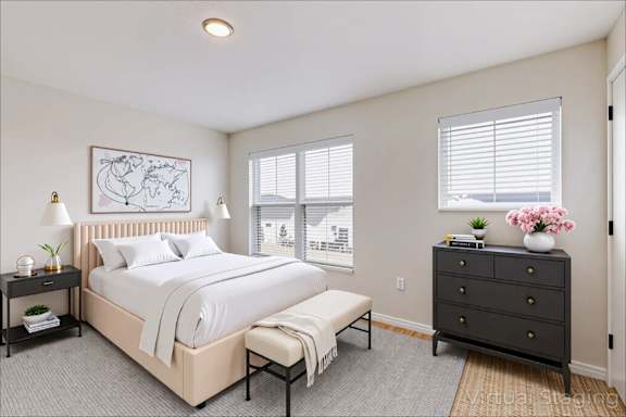 A bedroom with a large bed, a bench, and a dresser.