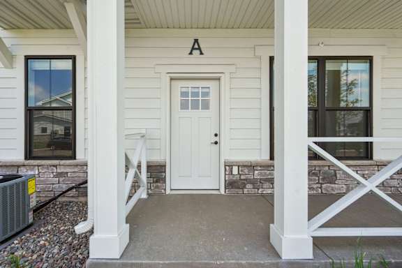 A white house with a door and windows.