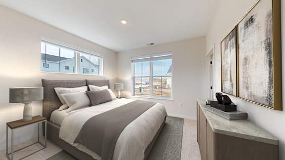 A bedroom with a large bed and a painting on the wall.